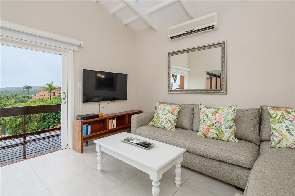 Villa 2409: Comfortable and spacious open plan lounge with sea views andsliding door to deck